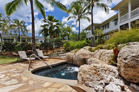Unwind in the resort community hot tub surrounded by natural stone landscaping and swaying palms in this tropical paradise.