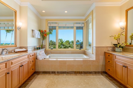 Soak in the deep tub while gazing out at the Pacific from this spa-inspired ensuite.