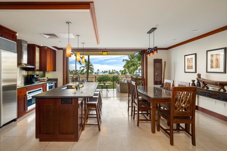 A Roy Yamaguchi-designed kitchen features stainless steel appliances and a cozy living area for a luxurious stay.