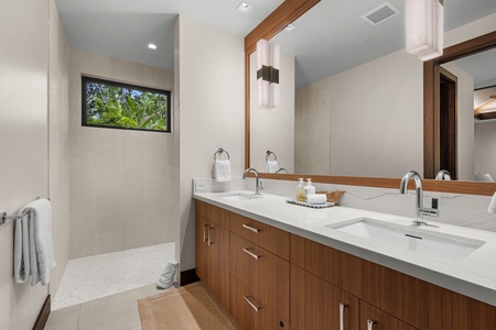 Guest Bedroom #3: Relax in your spa-inspired ensuite with a dual vanity, refined wood accents, and peaceful glimpses of the garden outside.
