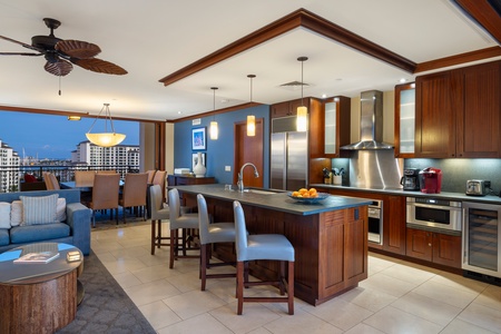 The fully-stocked kitchen features wide counter spaces for a breezy meal preparation.