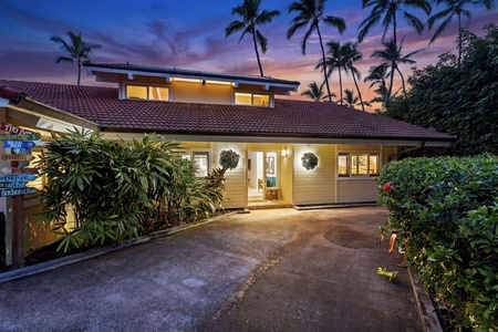 Arrive home to warm lighting and a peaceful, palm-lined setting.