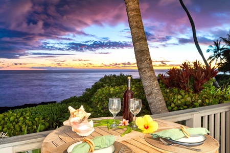 Sunset dining setup on the lanai with tropical decor and ocean views.