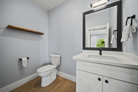 Ensuite bathroom includes a single vanity and bright natural light.