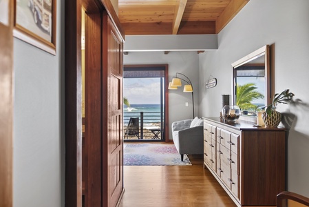 Bedroom with direct access to a private lanai and ocean views.