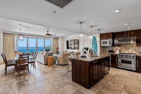 Open-concept living at Honua Kai Hokulani 825, with ocean views from kitchen to lanai.