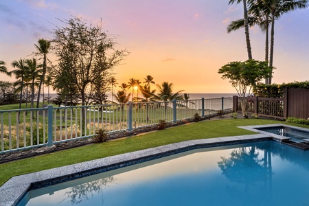 Relax poolside as the sky transforms with sunset hues.