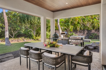 Outdoor dining area with seating for eight under a covered lanai, perfect for alfresco meals. Grill on a gas barbecue, gas-fired pizza oven or charcoal grill on The Green Egg.