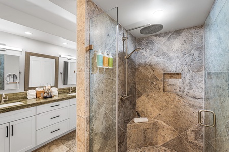 Indulge in a spa-like bath, with a walk-in stone shower and space to unwind.