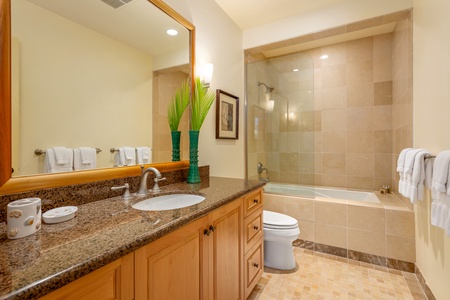 Freshen up in this well-appointed bathroom featuring granite countertops and a tub/shower combo.