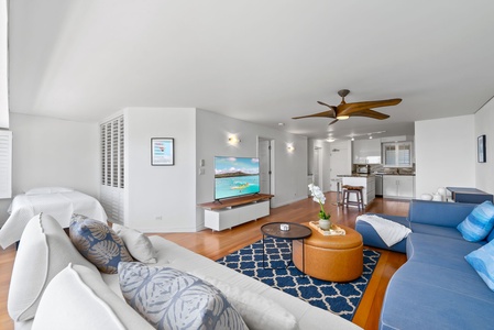 A bright and open living area with modern coastal décor and hardwood floors—ideal for relaxing after Waikiki adventures.
