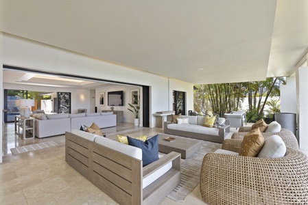 Seamless indoor-outdoor living with multiple seating areas for groups.