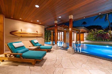 Covered poolside lounge with cushioned daybeds.