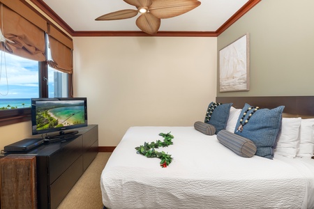 Wake to ocean views through your window while enjoying modern comforts like a flat-screen TV and ceiling fan in this thoughtfully appointed bedroom.