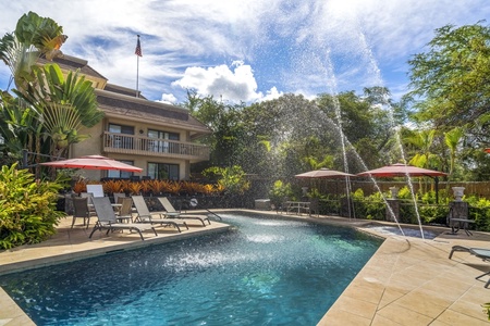 Resort-style pool area with lounge chairs for 10, providing a sunny tropical retreat.