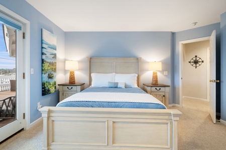 Sink into coastal tranquility in your serene bedroom, where soft blue walls and crisp white linens create the perfect seaside retreat.