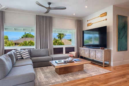 Cozy family room with a large TV and scenic window views.