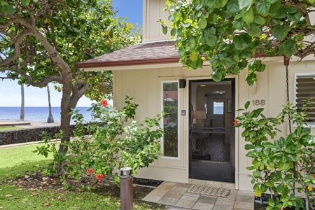 Welcome to your island escape—lush entry with tropical foliage just steps away from an expansive ocean front view.