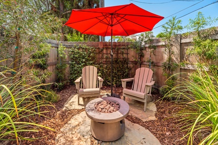 Soak up the sun by day and unwind under the stars by the fire pit in this charming backyard escape.