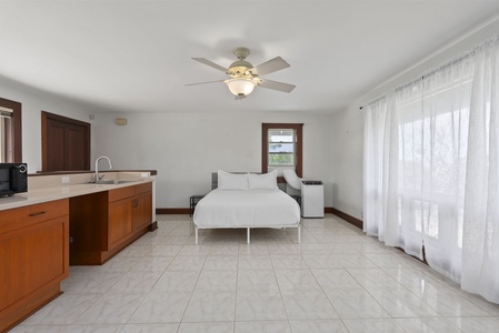 Bright guest suite with ceiling fan and private entry.