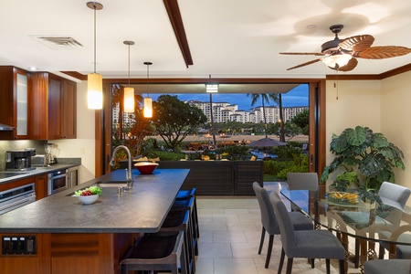 Seamless flow from the kitchen to the adjacent dining area with table for six.