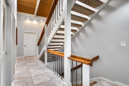 Stairs leading from the entry up to the Primary bedroom loft