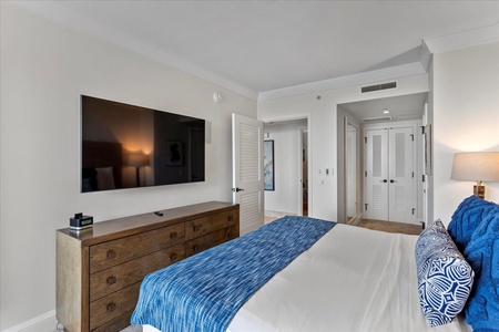 Relax in bed at Honua Kai Hokulani 825 and enjoy your favorite show on a large flat-screen TV.