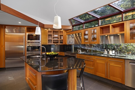 Spacious gourmet kitchen with a central island and natural lighting.