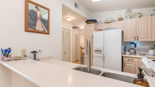 Framed art decorates the kitchen area.