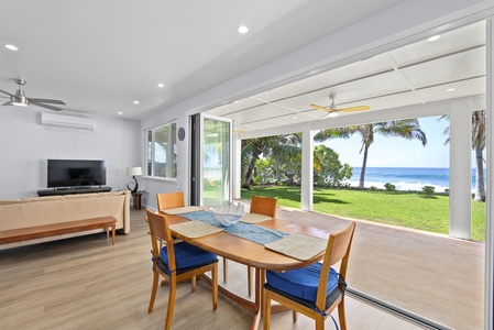 Oceanfront Luxury Dream Estate's indoor downstair dining with wall-to-wall ocean views and effortless outdoor flow.