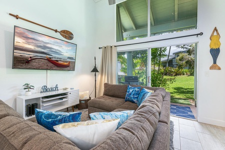Cozy great room with vaulted ceilings and lush garden views.