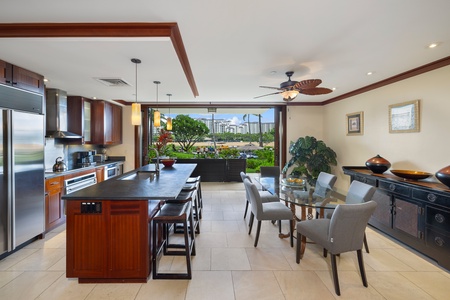 Enjoy the fully-equipped kitchen with top tier appliances and the elegant dining area featuring a glass table for six.