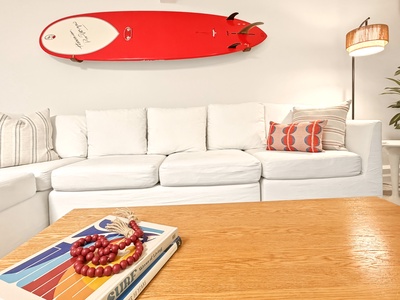 Sink into plush white cushions where coastal vibes meet modern comfort, perfect for unwinding after your beach adventures.