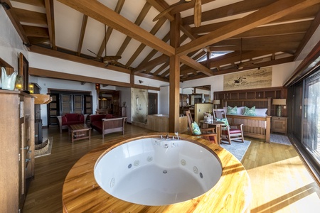 Indoor hot tub surrounded by warm wooden finishes and stunning views.