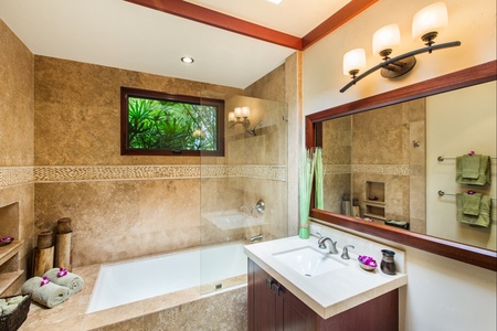 Downstairs east guest bathroom with elegant tilework and natural light.