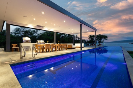 Luxurious poolside dining and lanai area, perfect for evening entertainment.