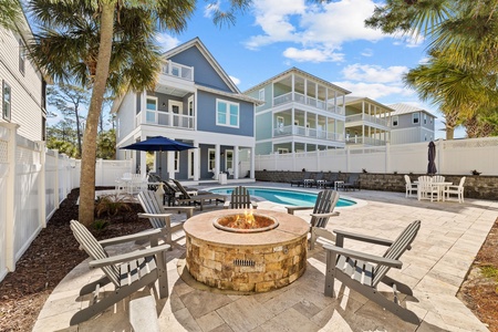 Spacious fenced in back yard with fire pit and pool