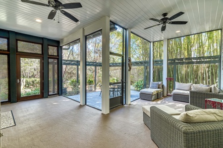 Screened-in front porch with cushioned seating