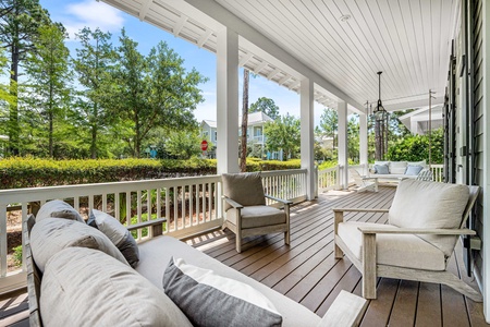 Covered front porch with cushioned seating sets