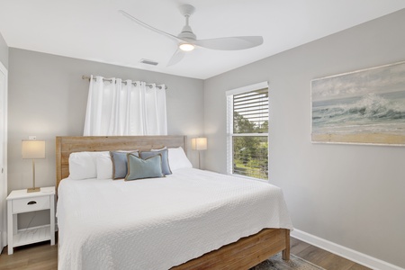 The primary bedroom, located on the 1st floor offers a King bed, TV and private bathroom