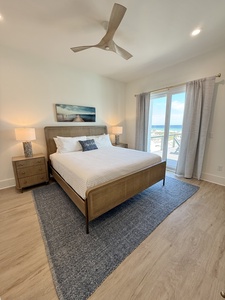 The master bedroom has balcony access and a private bathroom