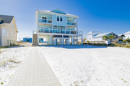 Vinyl boardwalk leads from the home to the pier