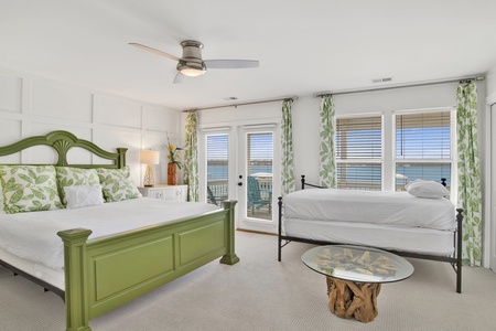 Master bedroom has a king bed, twin day bed, TV and private bathroom
