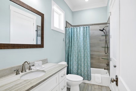 The bunk room has an attached bathroom with a tub/shower combo and is also accessible from the 1st floor hallway