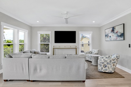 Roomy living space with a large mounted television