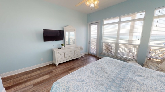 Main floor, Master bedroom featuring a king bed, TV with cable, access to the back deck and an attached, private bathroom.