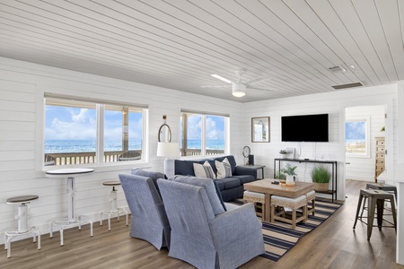 Spacious living room with flat screen TV and bistro table