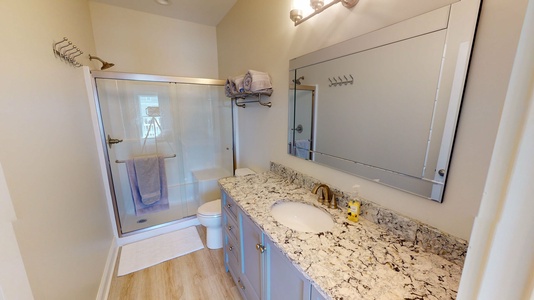 Bedroom 2 bath includes granite vanity and oversized, walk-in shower with shower seat