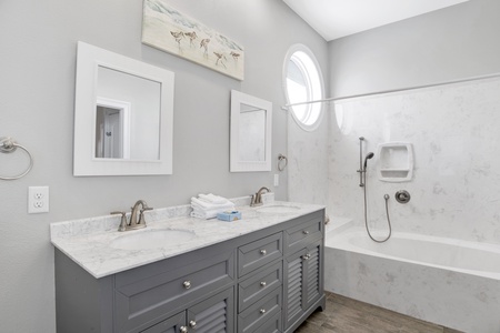 Loft bathroom with double vanity and tub/shower combo