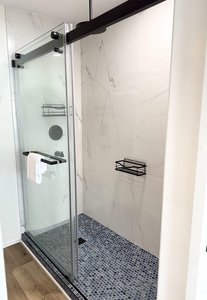 The master bath has tiled walk-in shower with a rain showerhead